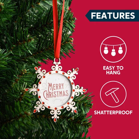 Merry Christmas snowflake ornament hanging on a Christmas tree